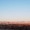 a blue sky above mountains and clouds