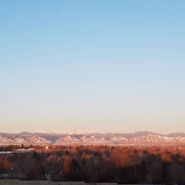 a blue sky above mountains and clouds