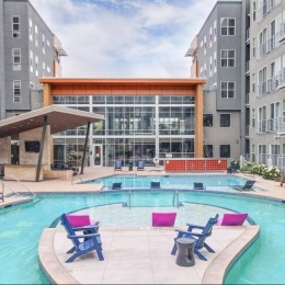 a swimming pool with outdoor chairs