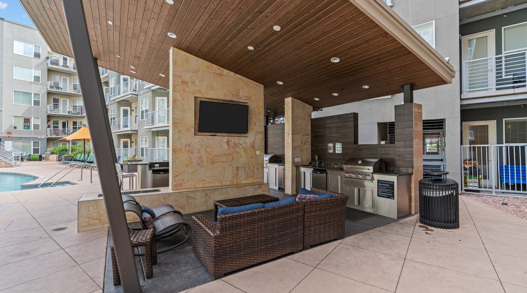 a cover patio with seating an a tv