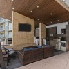 a cover patio with seating an a tv