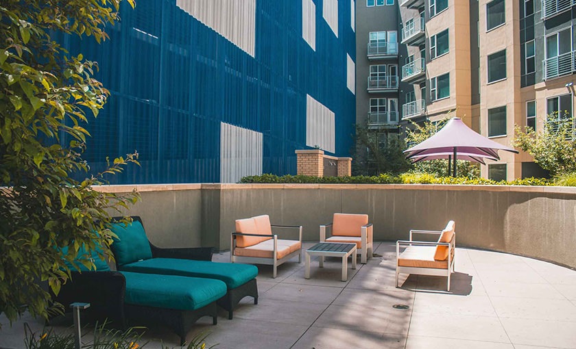 Access to resident-only features a seating area in a courtyard of a building