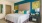 a bedroom with a bed and lamps