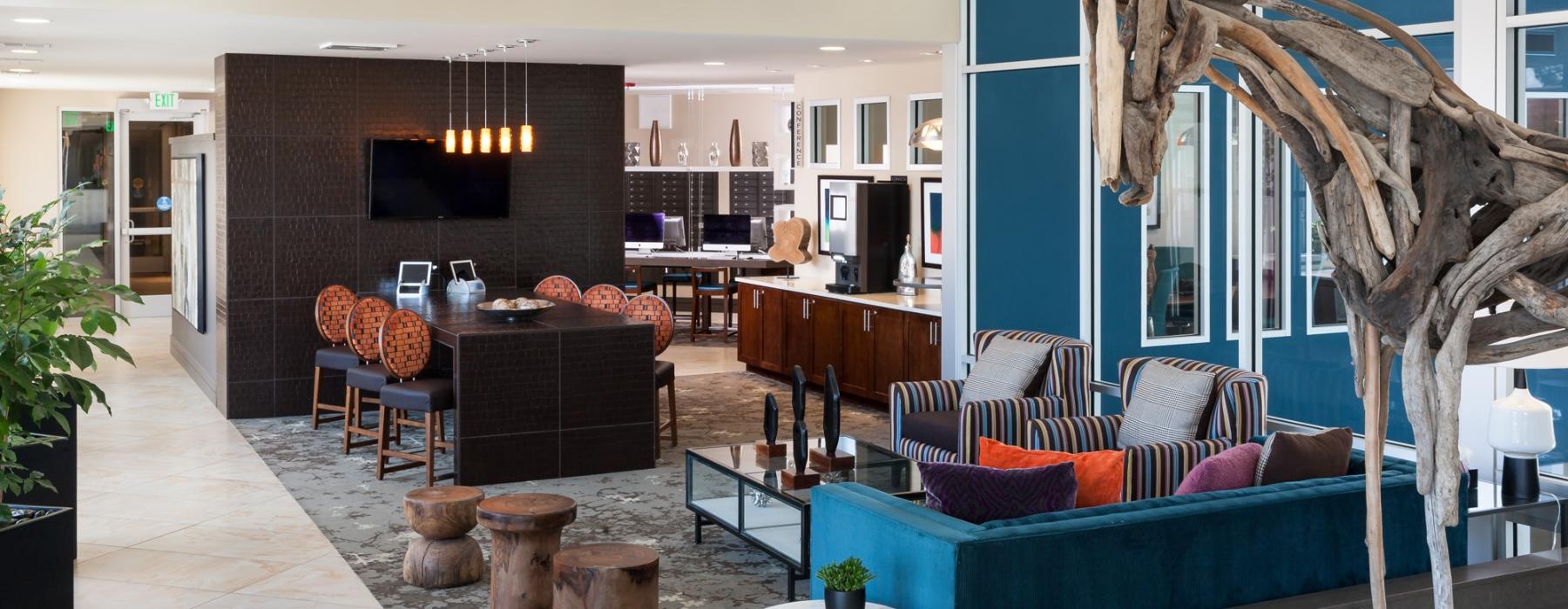 a lounge with seating tv and horse statue