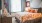 a bed with orange pillows